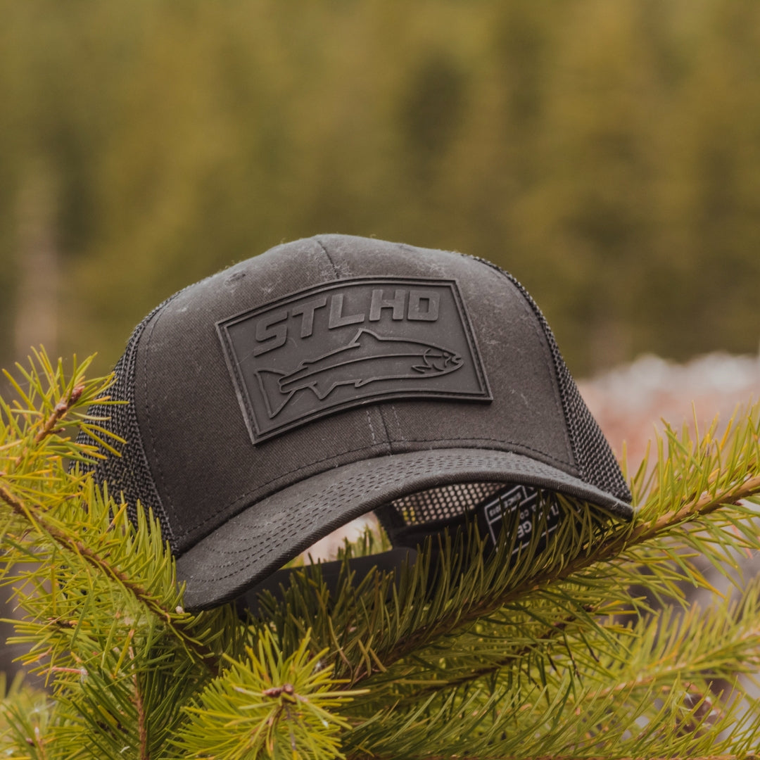 Black hat in black with the words "STLHD" written