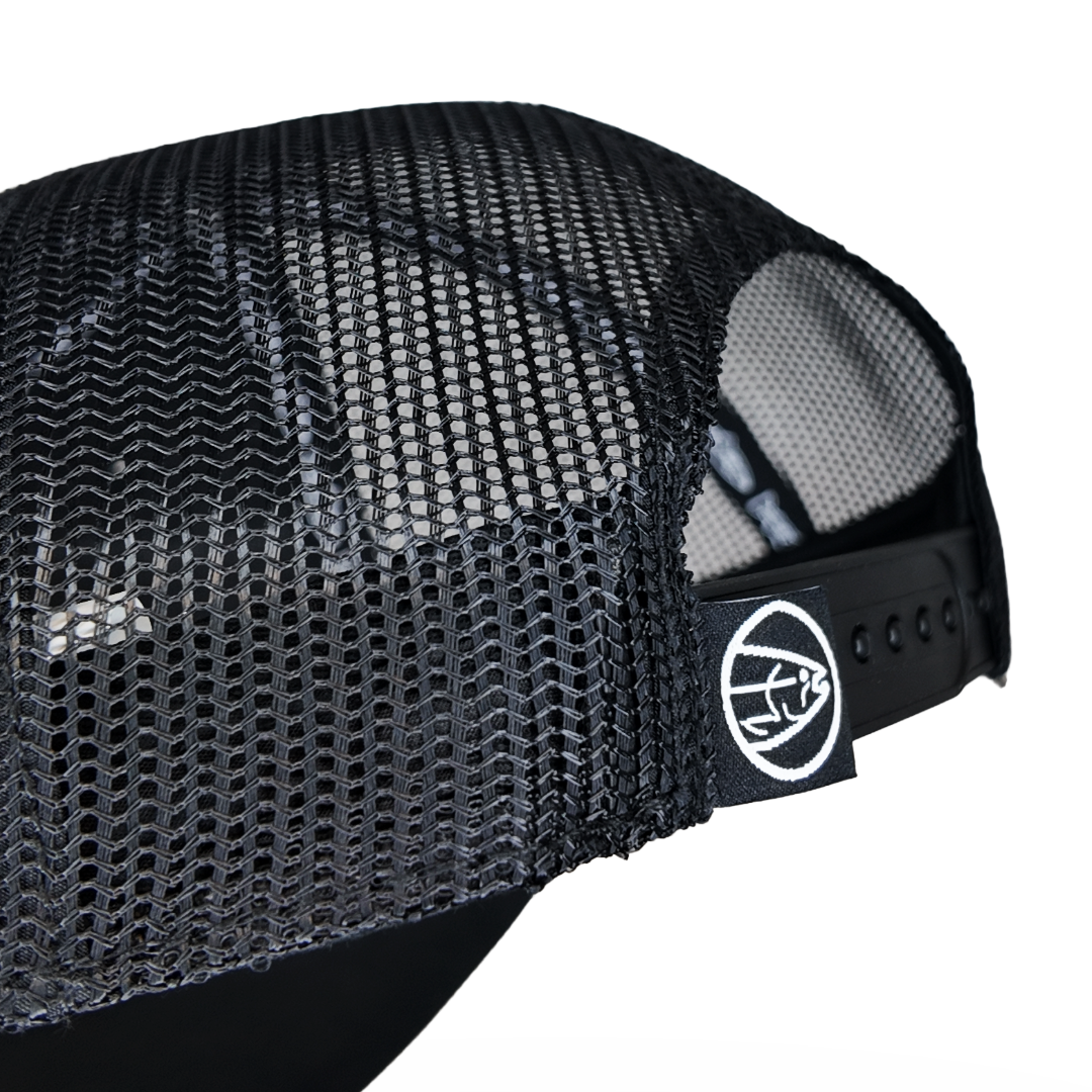 All-black STLHD Blackout Trucker hat with black logo on the front panel and black mesh back.